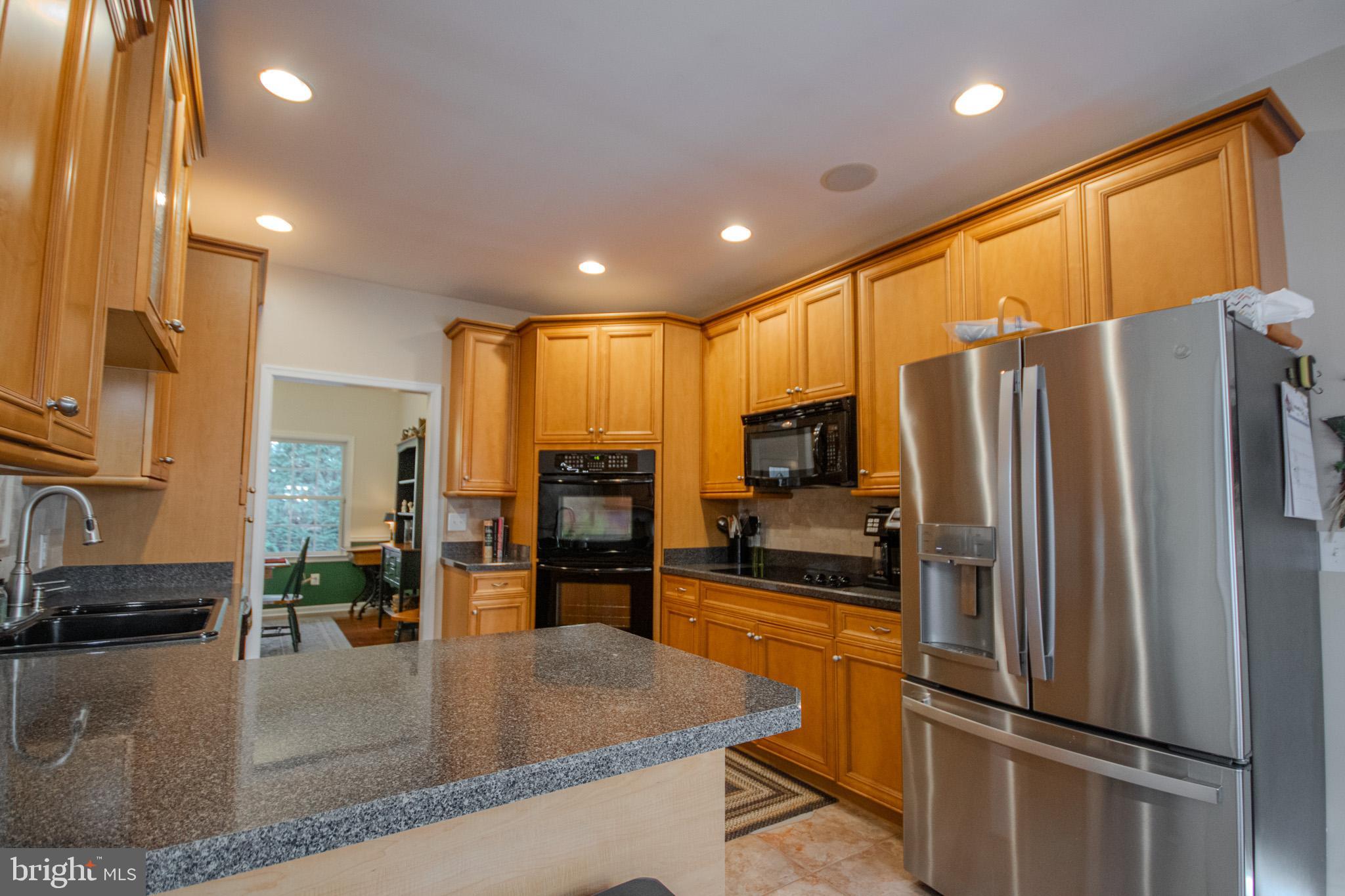 7395 Cherry Walk Road Hebron, MD 21830 - Photo 20 of 61 a kitchen with stainless steel appliances granite countertop a refrigerator a stove and a sink