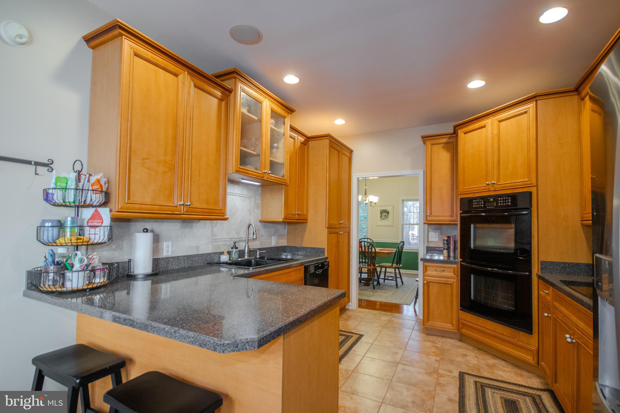 7395 Cherry Walk Road Hebron, MD 21830 - Photo 21 of 61 a kitchen with stainless steel appliances granite countertop a sink a stove and a refrigerator