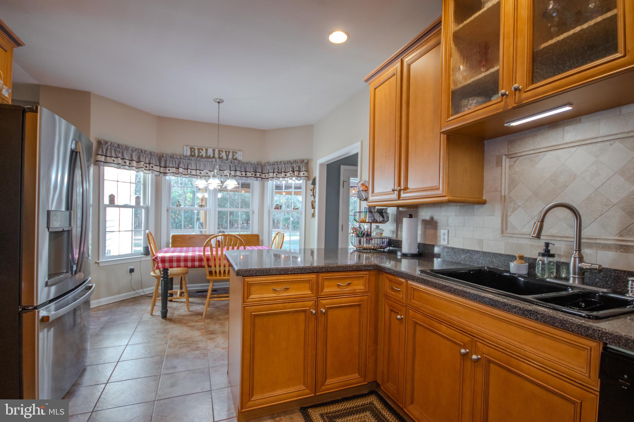 7395 Cherry Walk Road Hebron, MD 21830 - Photo 22 of 61 a kitchen with stainless steel appliances granite countertop a sink and cabinets