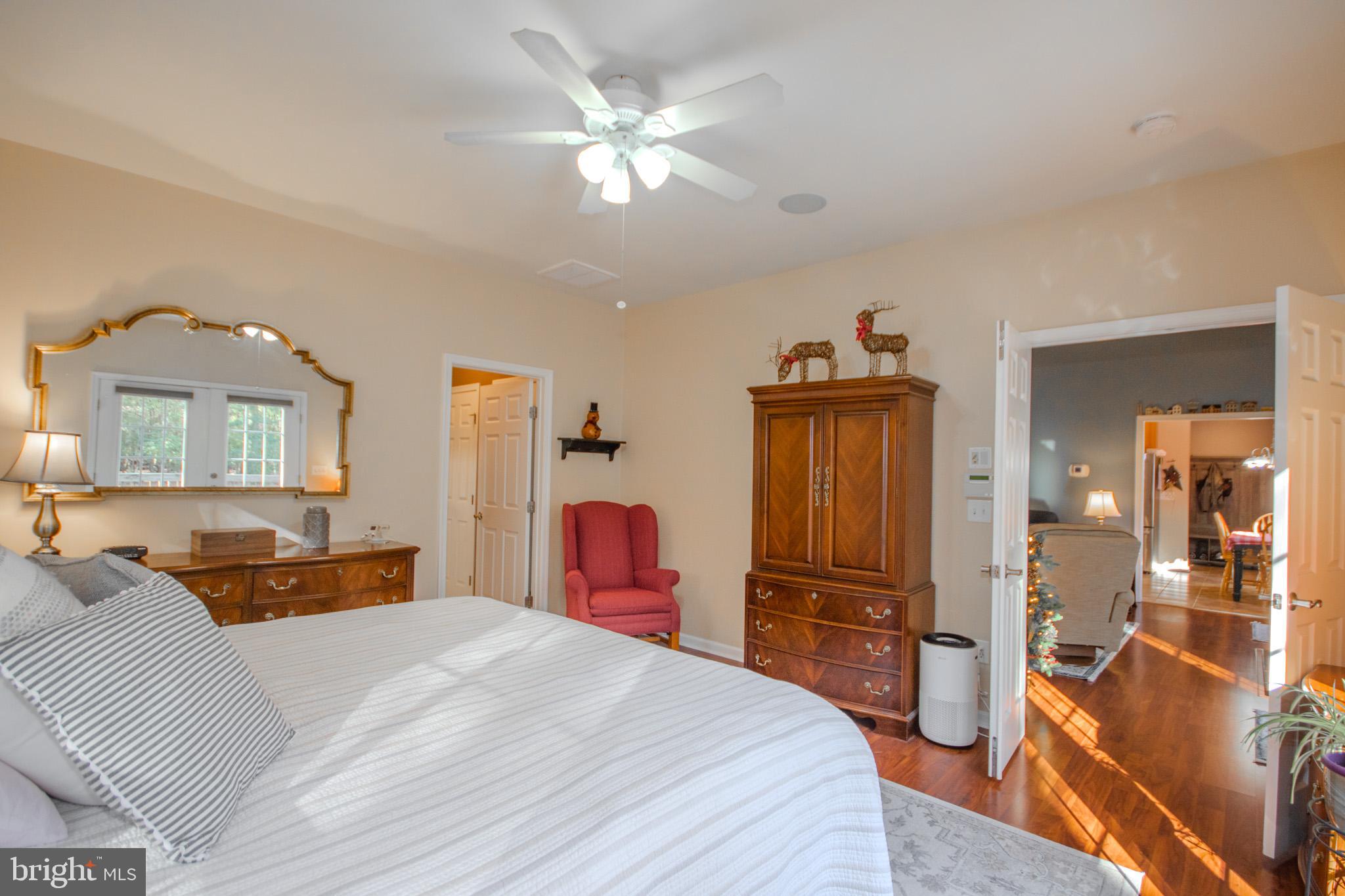 7395 Cherry Walk Road Hebron, MD 21830 - Photo 26 of 61 a bedroom with a bed and a chandelier