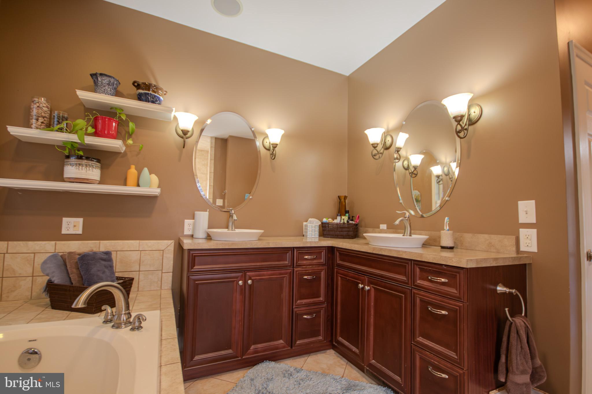 7395 Cherry Walk Road Hebron, MD 21830 - Photo 29 of 61 a bathroom with a sink double vanity and a mirror