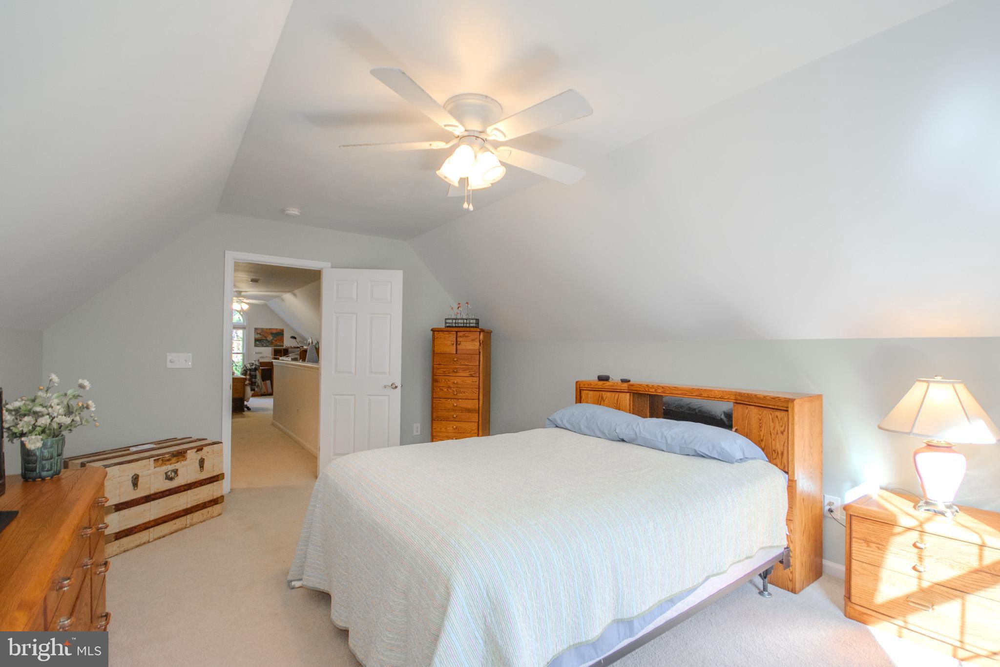 7395 Cherry Walk Road Hebron, MD 21830 - Photo 42 of 61 a bedroom with a bed and a chandelier