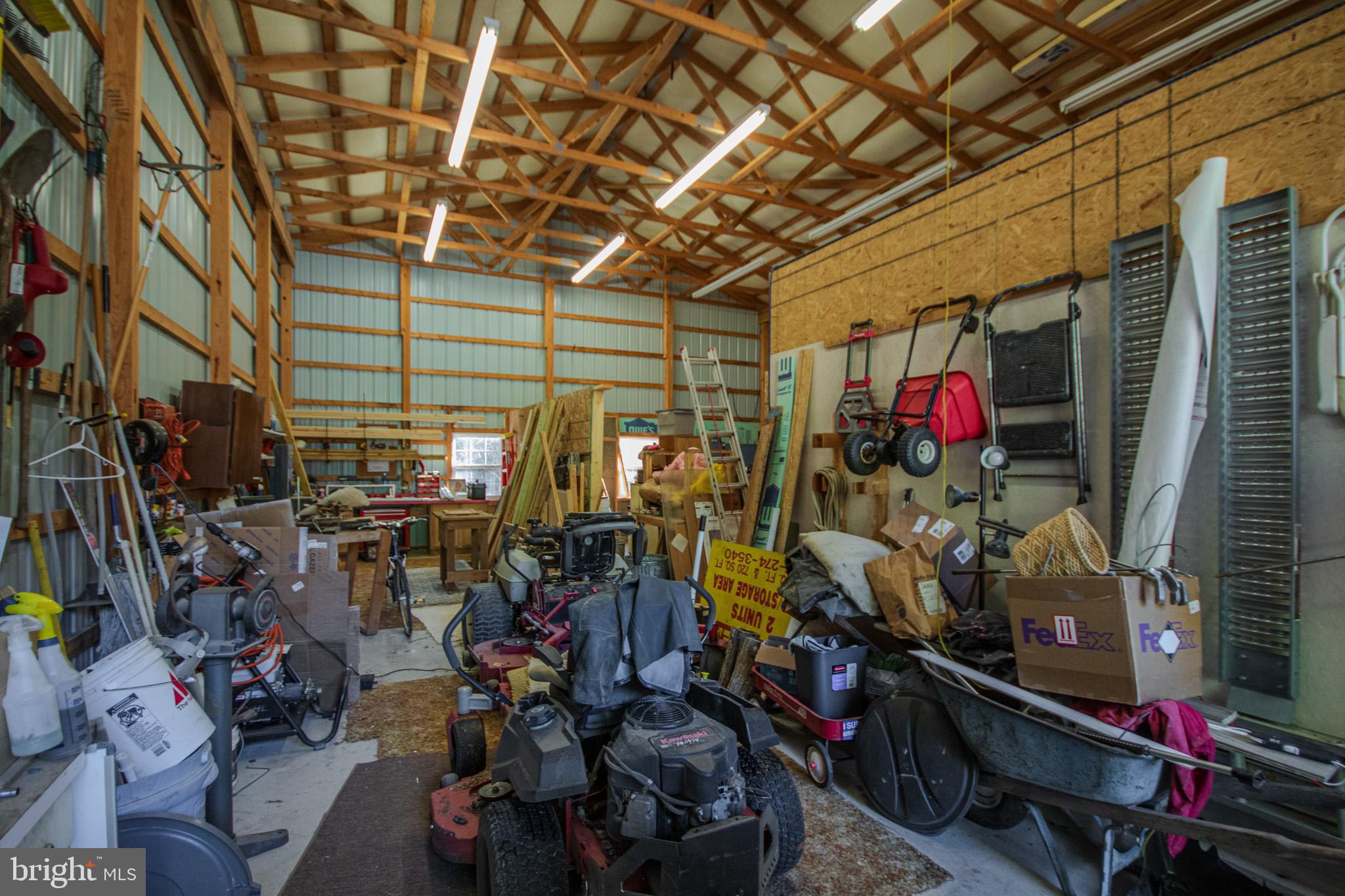 7395 Cherry Walk Road Hebron, MD 21830 - Photo 49 of 61 Spacious workshop brimming with tools and gear.