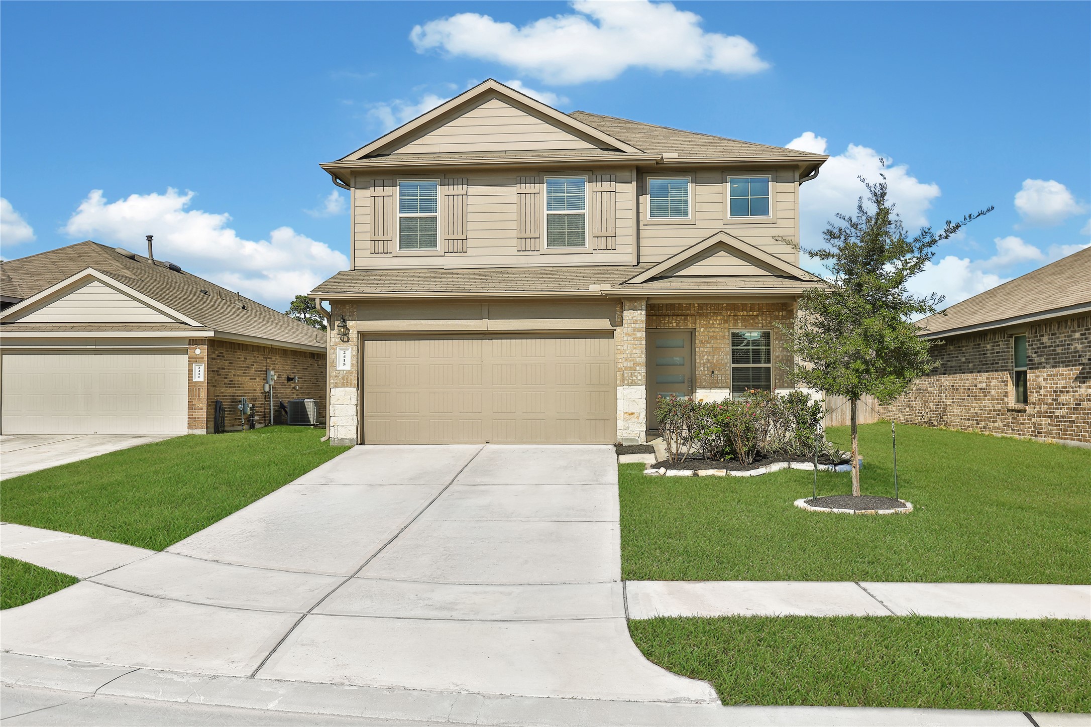 2415 Sutton Hollow Court Spring, TX 77373 - Photo 1 of 40 a front view of a house with a yard and garage