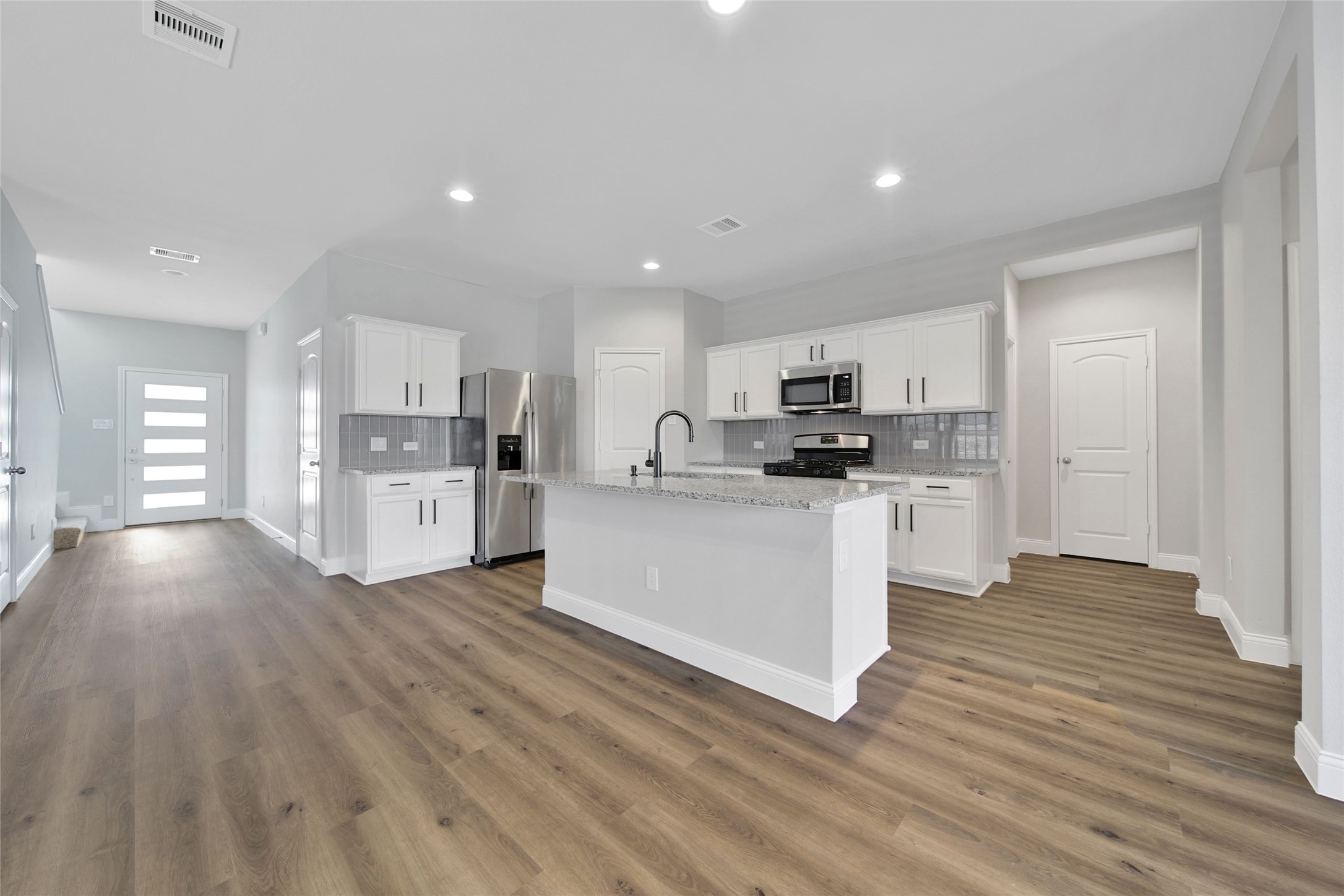 2415 Sutton Hollow Court Spring, TX 77373 - Photo 11 of 40 a kitchen with stainless steel appliances a refrigerator sink and cabinets