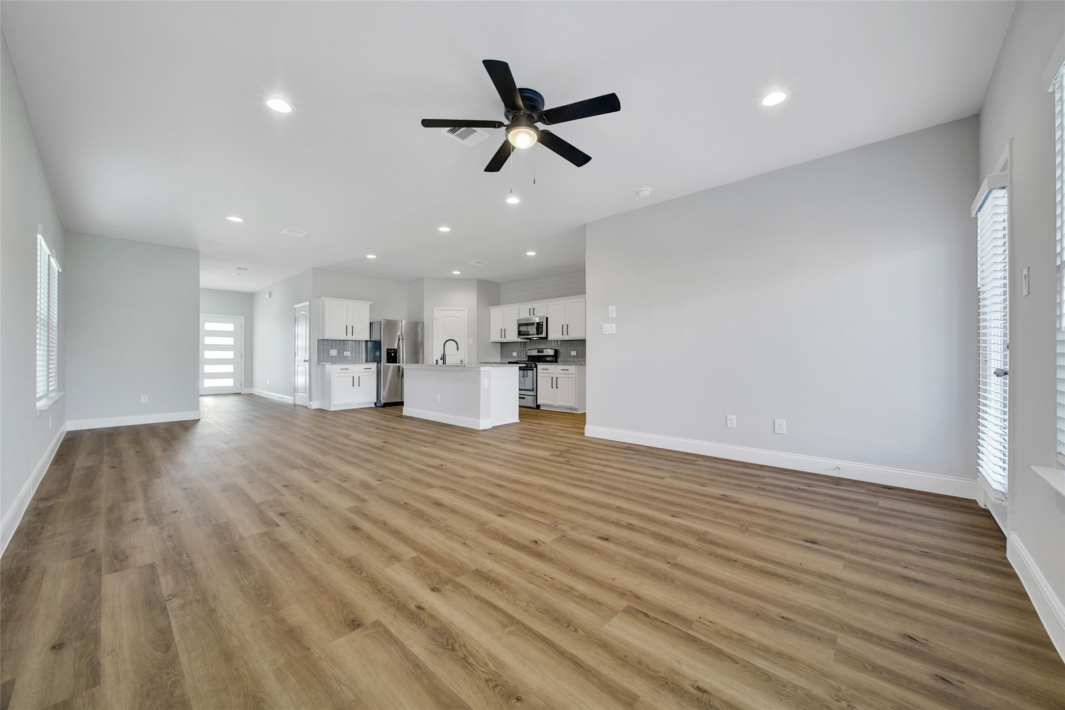 2415 Sutton Hollow Court Spring, TX 77373 - Photo 14 of 40 a view of empty room with wooden floor and ceiling fan