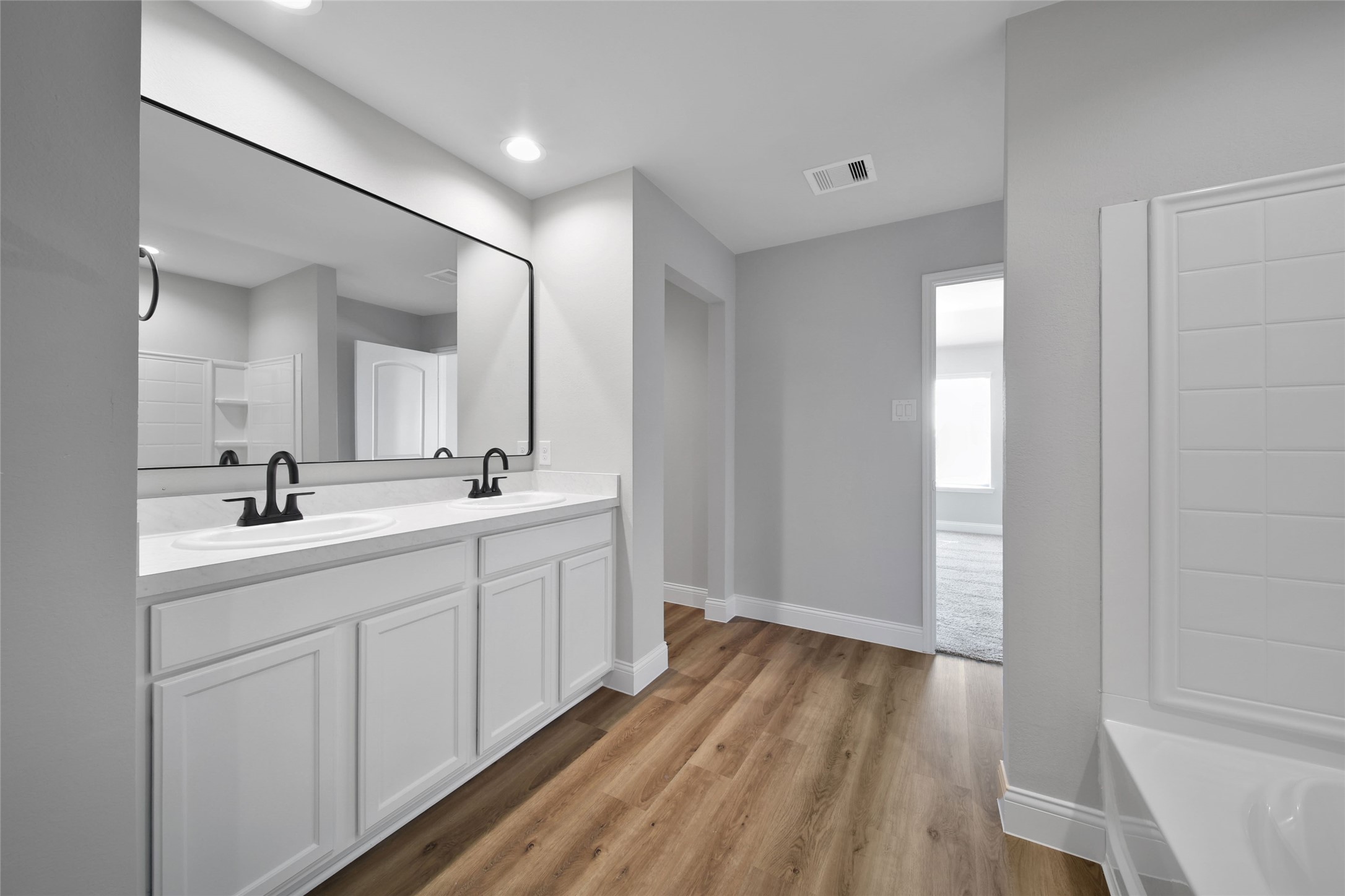 2415 Sutton Hollow Court Spring, TX 77373 - Photo 26 of 40 a bathroom with a sink and mirror