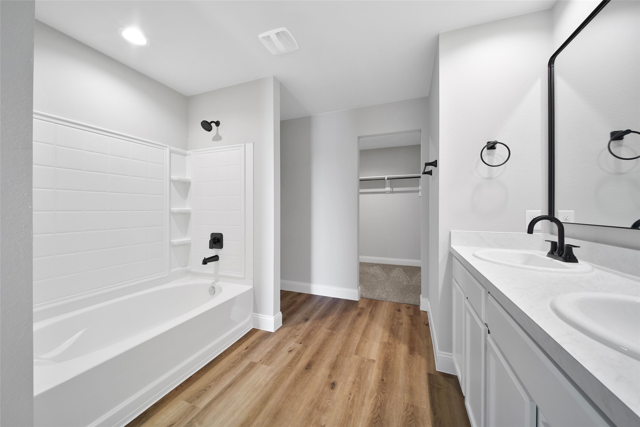 2415 Sutton Hollow Court Spring, TX 77373 - Photo 27 of 40 a spacious bathroom with a tub sink and mirror