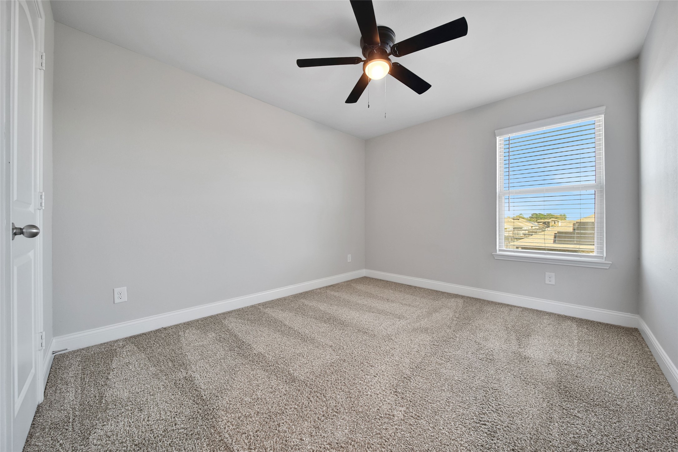 2415 Sutton Hollow Court Spring, TX 77373 - Photo 29 of 40 an empty room with a window and a fan
