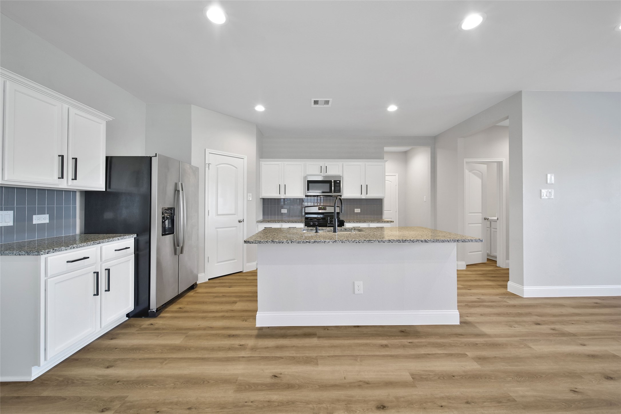 2415 Sutton Hollow Court Spring, TX 77373 - Photo 5 of 40 a large kitchen with stainless steel appliances