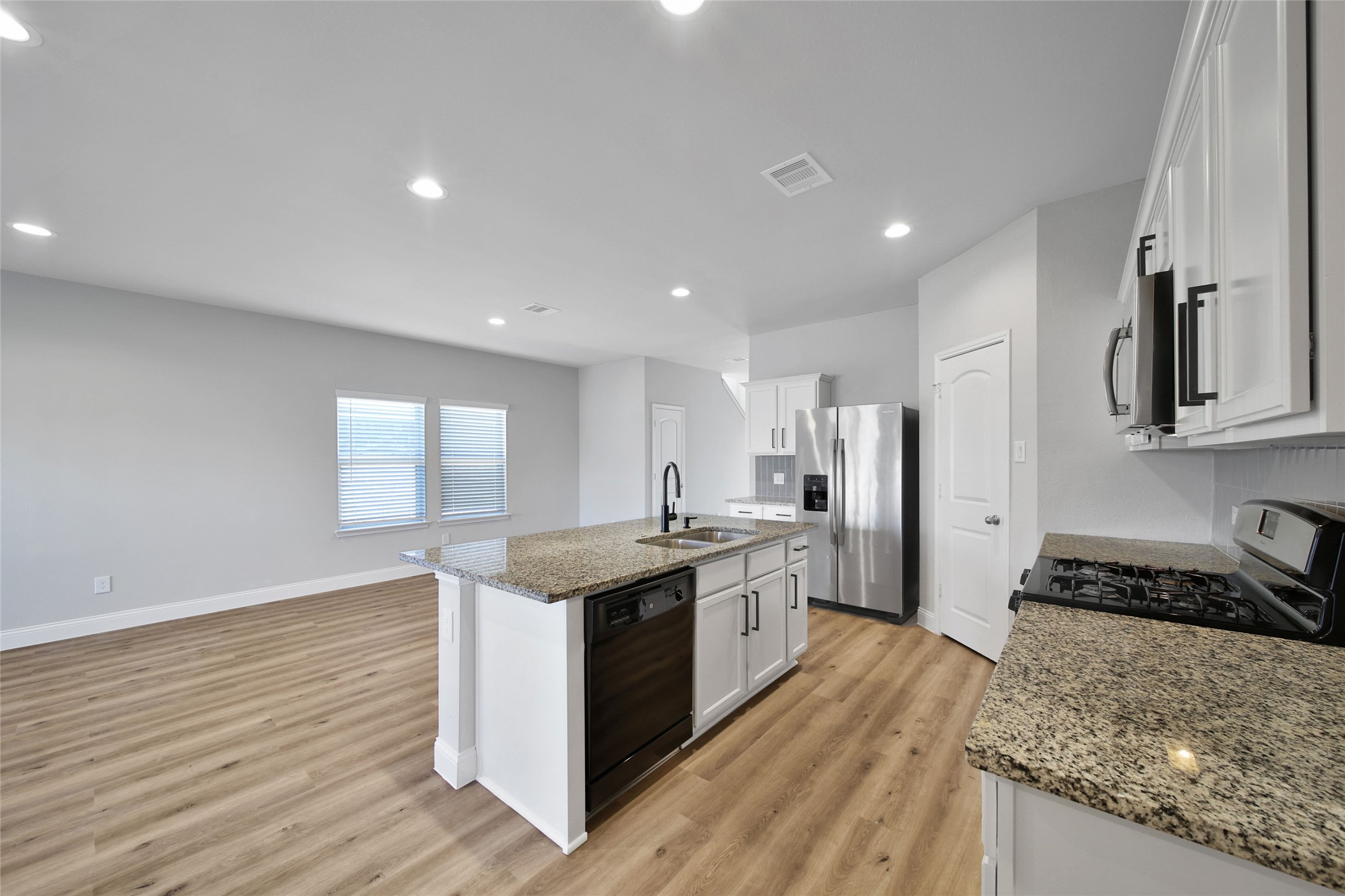 2415 Sutton Hollow Court Spring, TX 77373 - Photo 9 of 40 a kitchen with stainless steel appliances granite countertop a stove and a sink