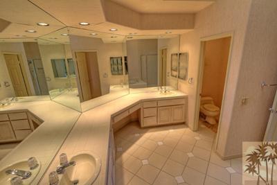 56565 Riviera La Quinta, CA 92253 - Photo 12 of 25 a bathroom with a double vanity sink toilet and shower