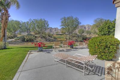 56565 Riviera La Quinta, CA 92253 - Photo 21 of 25 a view of a road with a bench in front of the house