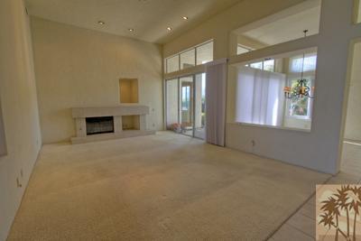 56565 Riviera La Quinta, CA 92253 - Photo 10 of 25 a view of an empty room with a fireplace and a window