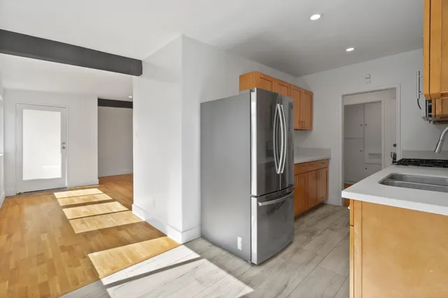 a kitchen with a refrigerator and a sink