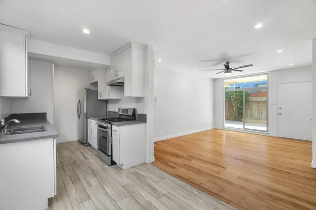 a kitchen with granite countertop a stove and a sink