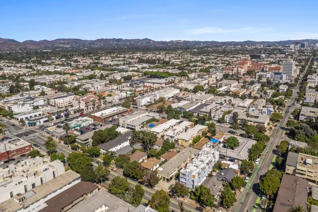 an aerial view of residential houses with city view