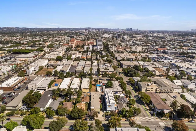 an aerial view of residential houses with city view