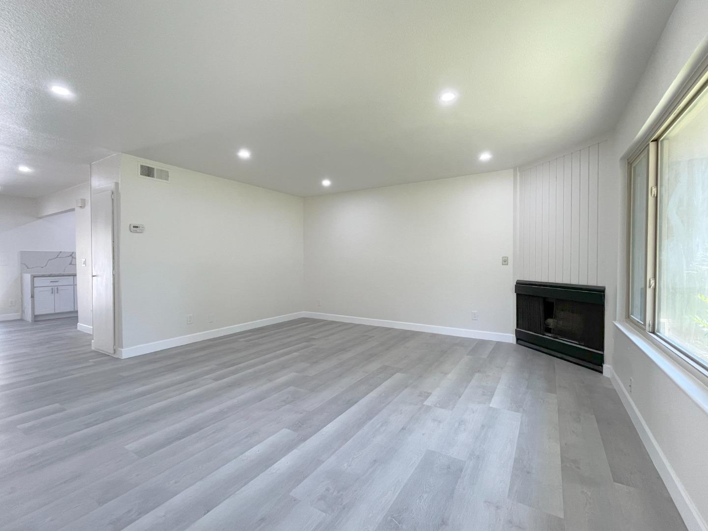5070 Plaza Corona Santa Clara, CA 95054 - Photo 2 of 18 an empty room with wooden floor and windows
