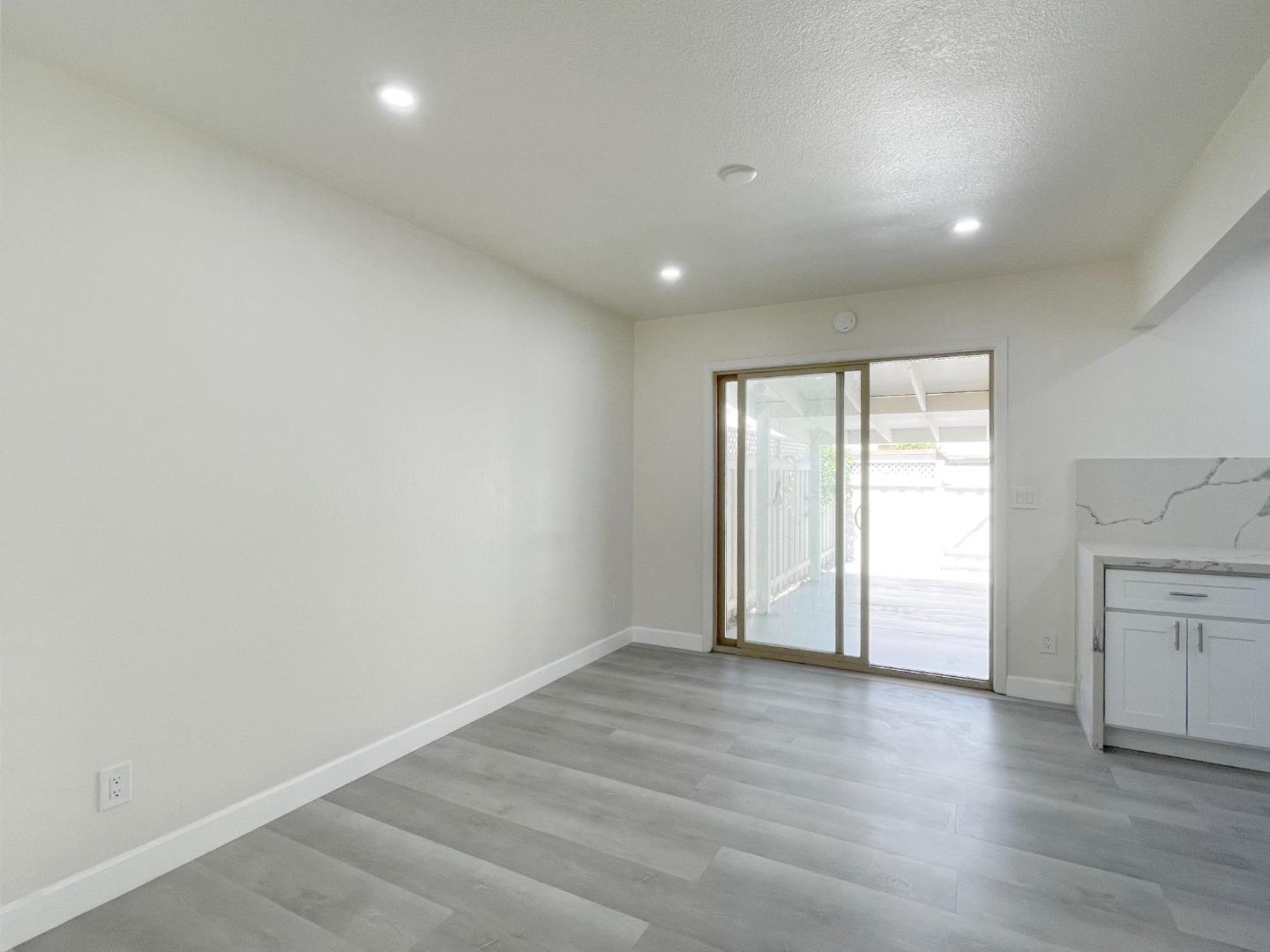 5070 Plaza Corona Santa Clara, CA 95054 - Photo 4 of 18 an empty room with wooden floor and window