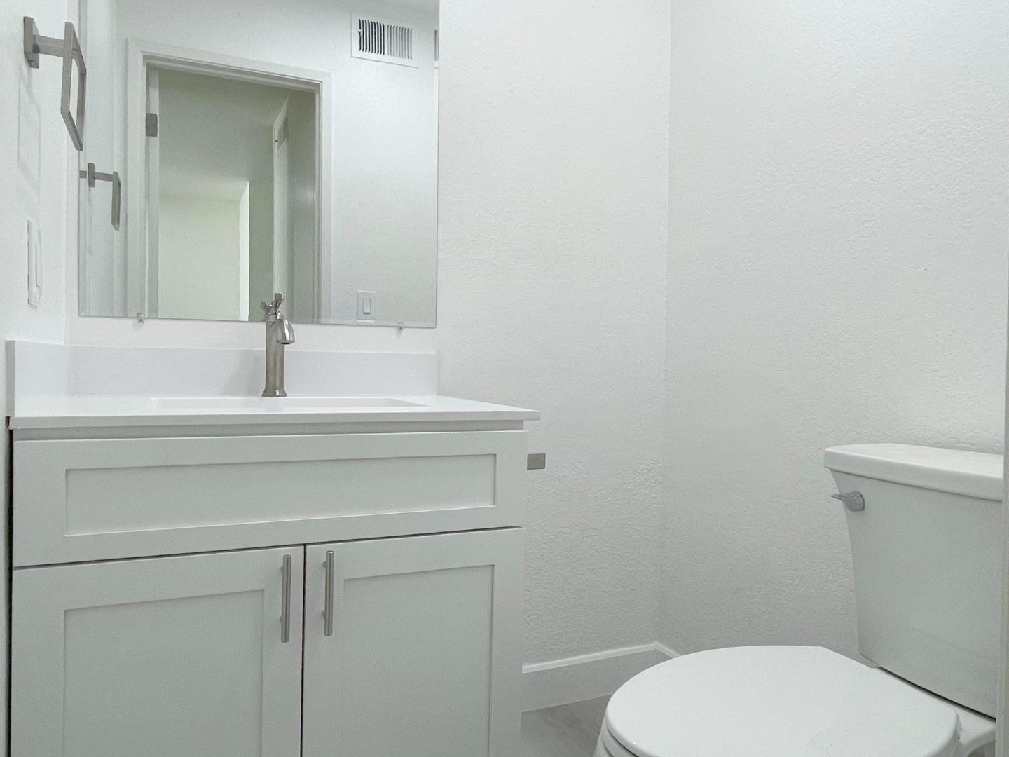 5070 Plaza Corona Santa Clara, CA 95054 - Photo 9 of 18 a bathroom with a toilet sink and mirror