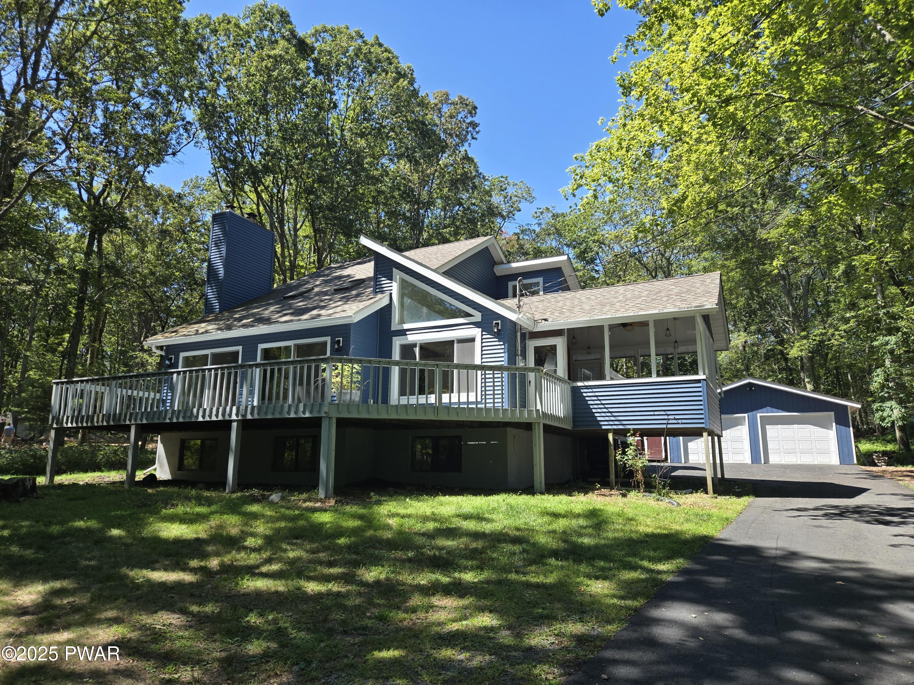 120 Rodeo Lane Hawley, PA 18428 - Photo 1 of 36 a front view of a house with a garden