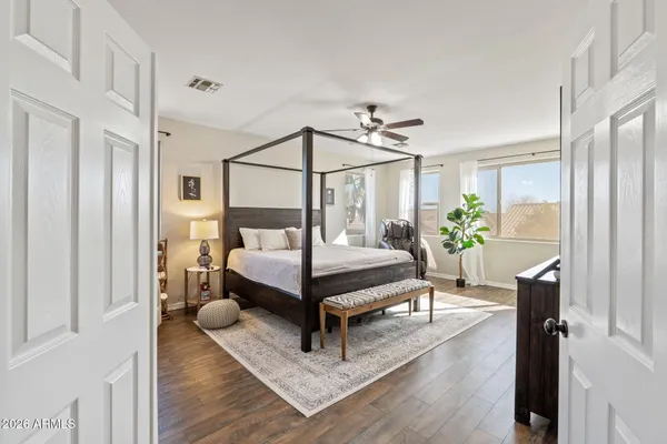 a bedroom with a bed and wooden floor