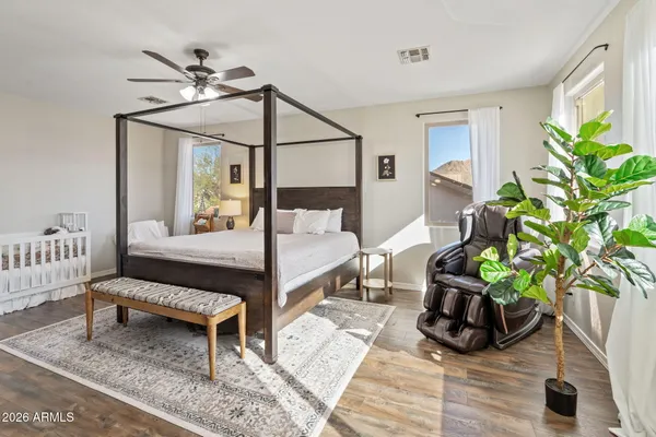 a bedroom with a bed and a chandelier