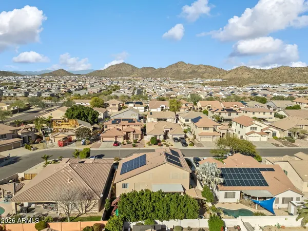 an aerial view of residential houses with outdoor space and trees