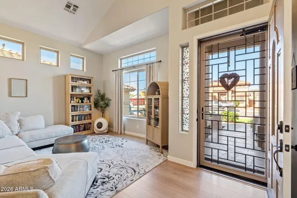 a living room with furniture a rug and white walls