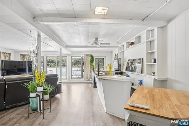 a kitchen with refrigerator and wooden floor