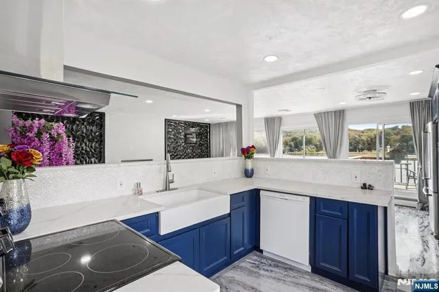 a kitchen with stainless steel appliances a sink and a refrigerator