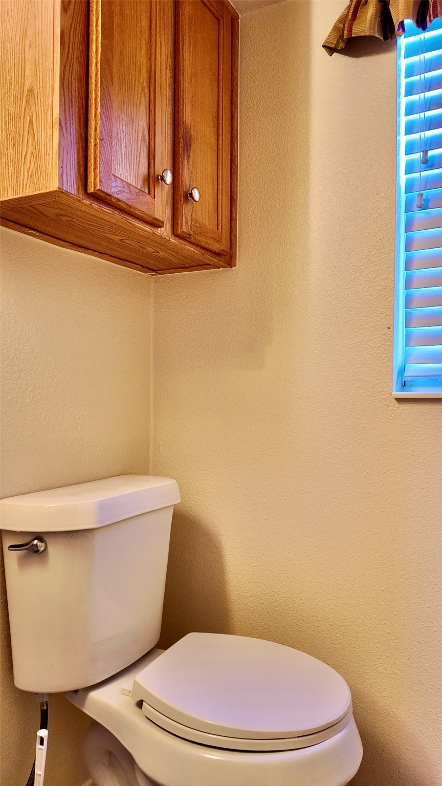 11720 Thousand Trail, Unit 13 Conroe, TX 77304 - Photo 16 of 35 a white toilet sitting next to a bathroom sink