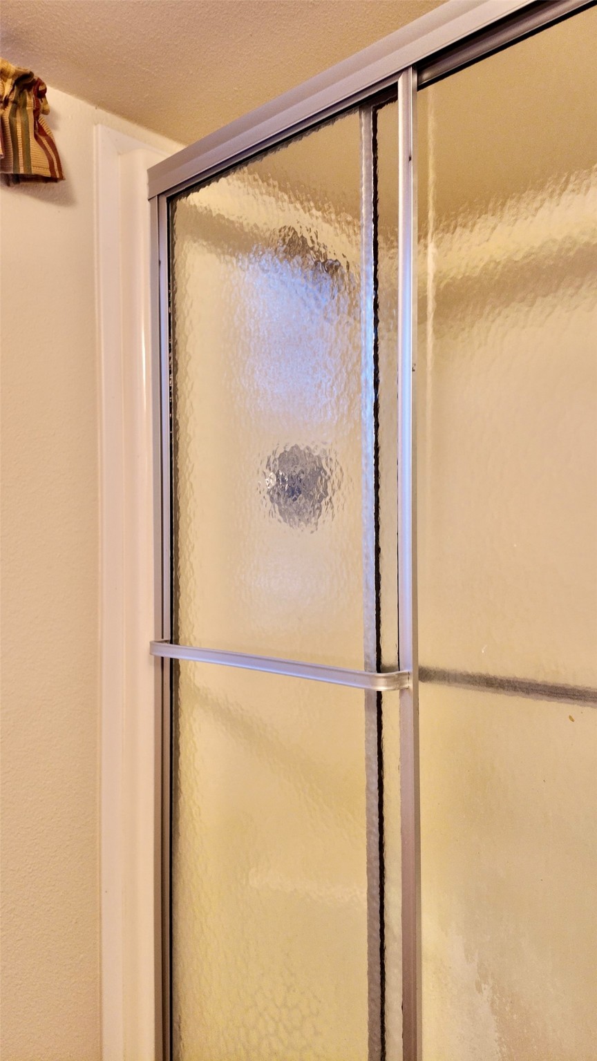 11720 Thousand Trail, Unit 13 Conroe, TX 77304 - Photo 18 of 35 a bathroom with a glass shower door