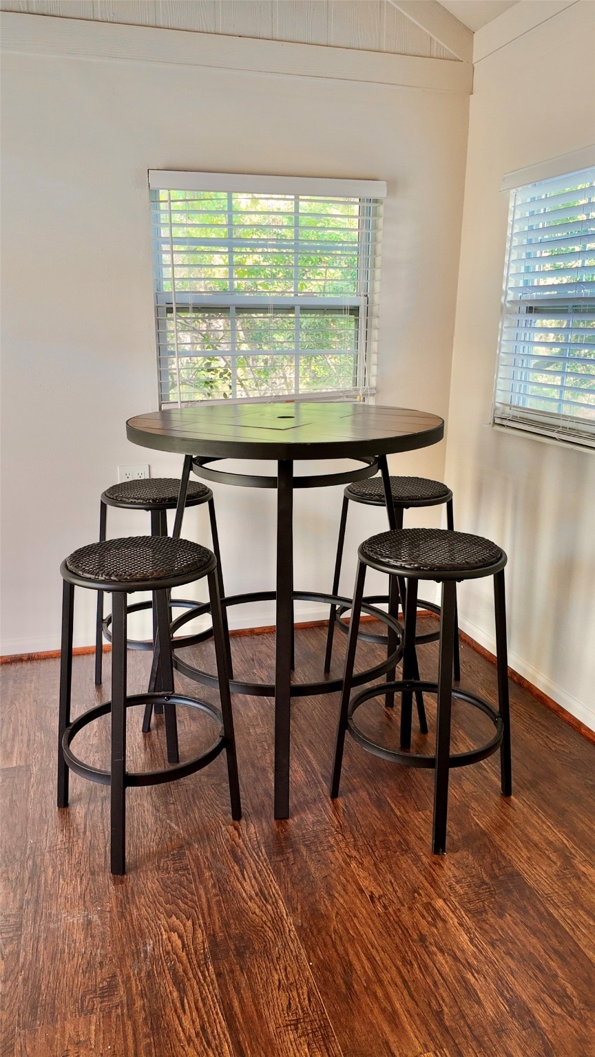 11720 Thousand Trail, Unit 13 Conroe, TX 77304 - Photo 19 of 35 a view of a dining room with furniture window and wooden floor
