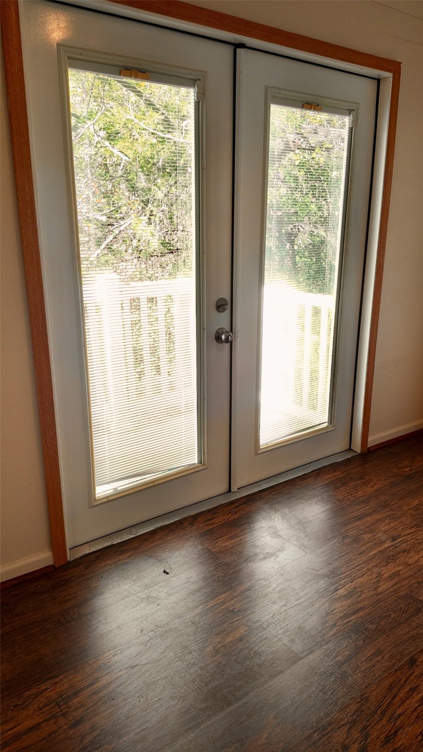 11720 Thousand Trail, Unit 13 Conroe, TX 77304 - Photo 20 of 35 a view of an empty room with wooden floor and a window