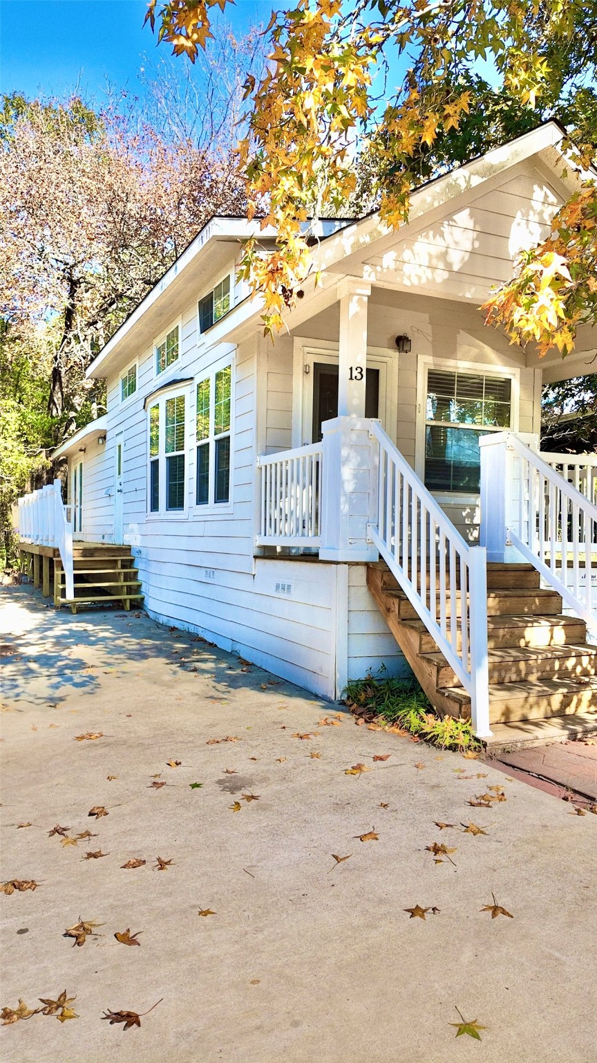 11720 Thousand Trail, Unit 13 Conroe, TX 77304 - Photo 2 of 35 a front view of a house with a yard