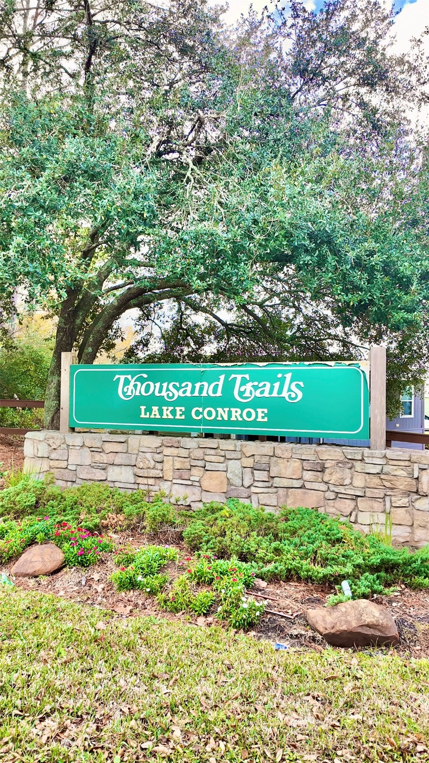 11720 Thousand Trail, Unit 13 Conroe, TX 77304 - Photo 27 of 35 a view of a yard with a bench