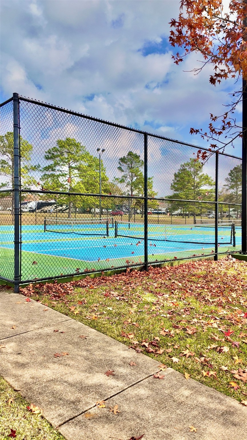 11720 Thousand Trail, Unit 13 Conroe, TX 77304 - Photo 33 of 35 a view of outdoor space with playground and green space