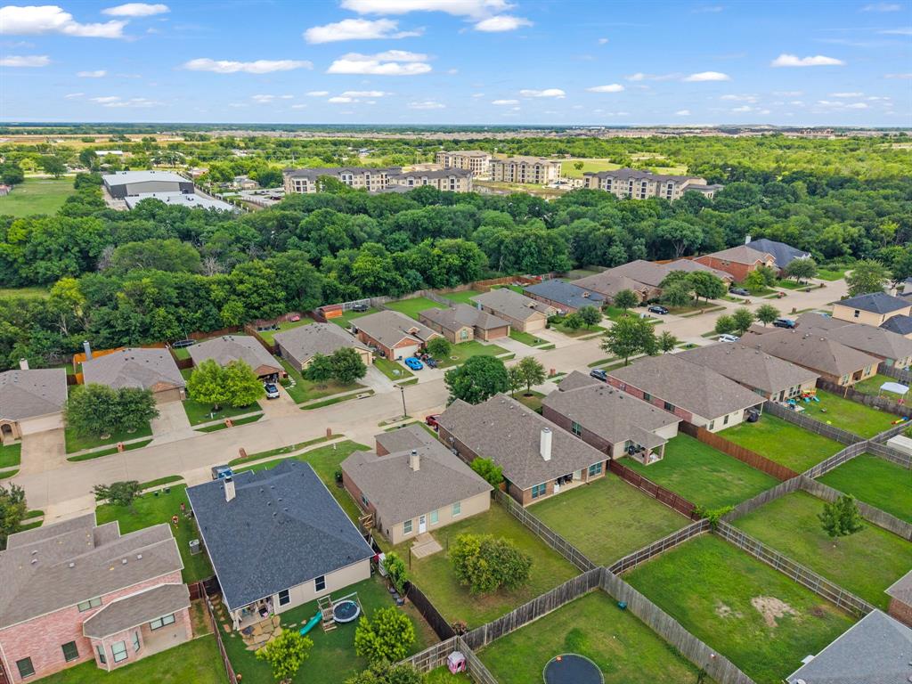 834 Hazel's Way Anna, TX 75409 - Photo 21 of 21 Aerial perspective showcasing a residential neighborhood with single-story homes, individual fenced backyards, paved streets, and abundant mature trees