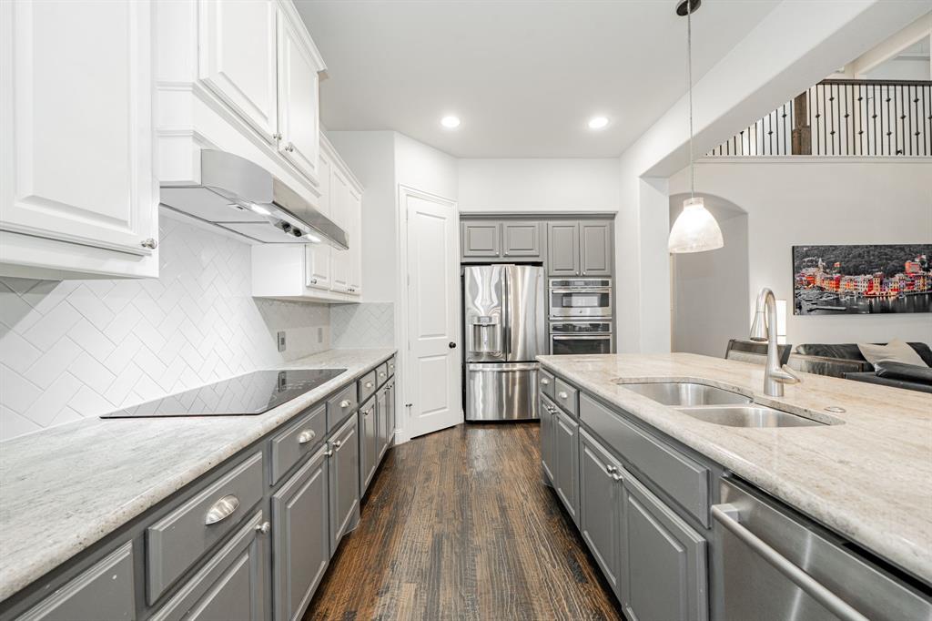 944 Highpoint Way Roanoke, TX 76262 - Photo 12 of 39 a large white kitchen with a sink and dishwasher