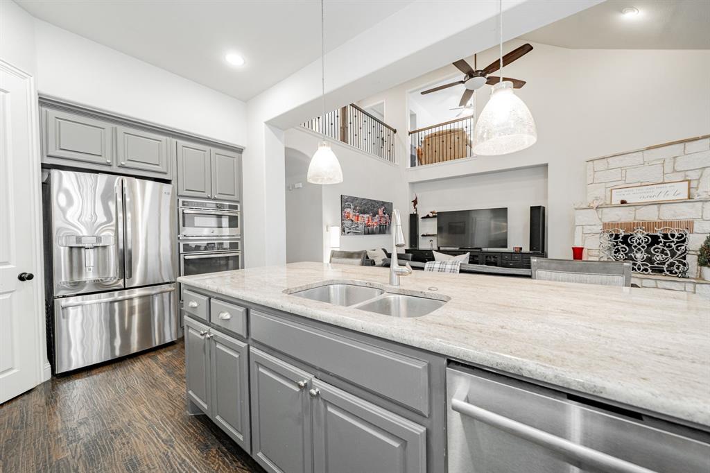 944 Highpoint Way Roanoke, TX 76262 - Photo 13 of 39 a kitchen with stainless steel appliances a sink and a refrigerator