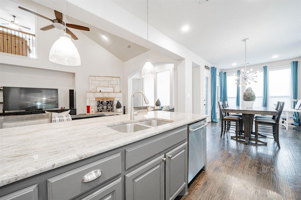 944 Highpoint Way Roanoke, TX 76262 - Photo 15 of 39 a large kitchen with kitchen island a large island in it