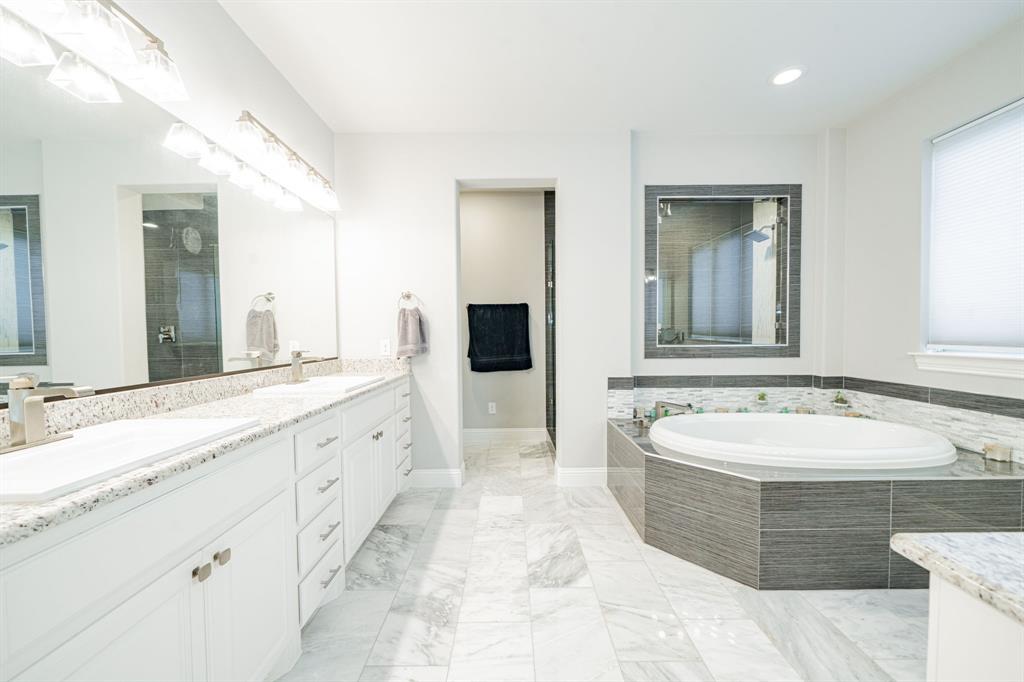 944 Highpoint Way Roanoke, TX 76262 - Photo 18 of 39 a spacious bathroom with a bathtub sink and mirror