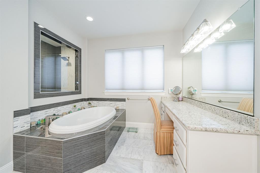 944 Highpoint Way Roanoke, TX 76262 - Photo 19 of 39 a bathroom with a granite countertop tub sink and mirror