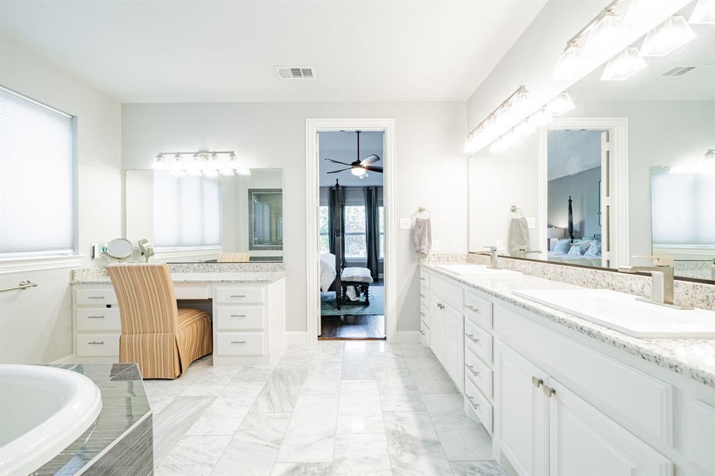 944 Highpoint Way Roanoke, TX 76262 - Photo 20 of 39 a large white bathroom with a large tub sink and double vanity