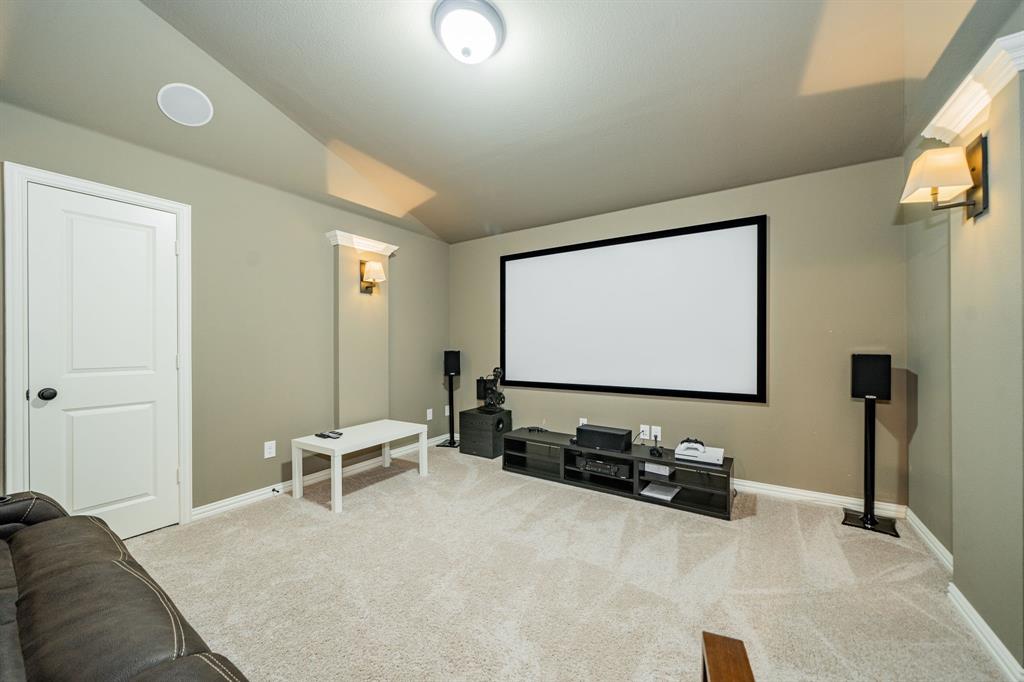 944 Highpoint Way Roanoke, TX 76262 - Photo 30 of 39 a living room with furniture and a flat screen tv