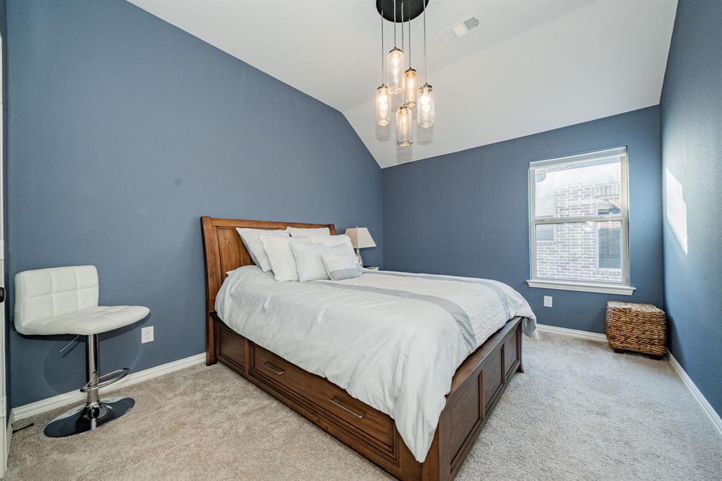 944 Highpoint Way Roanoke, TX 76262 - Photo 32 of 39 a bedroom with a bed chandelier and a window