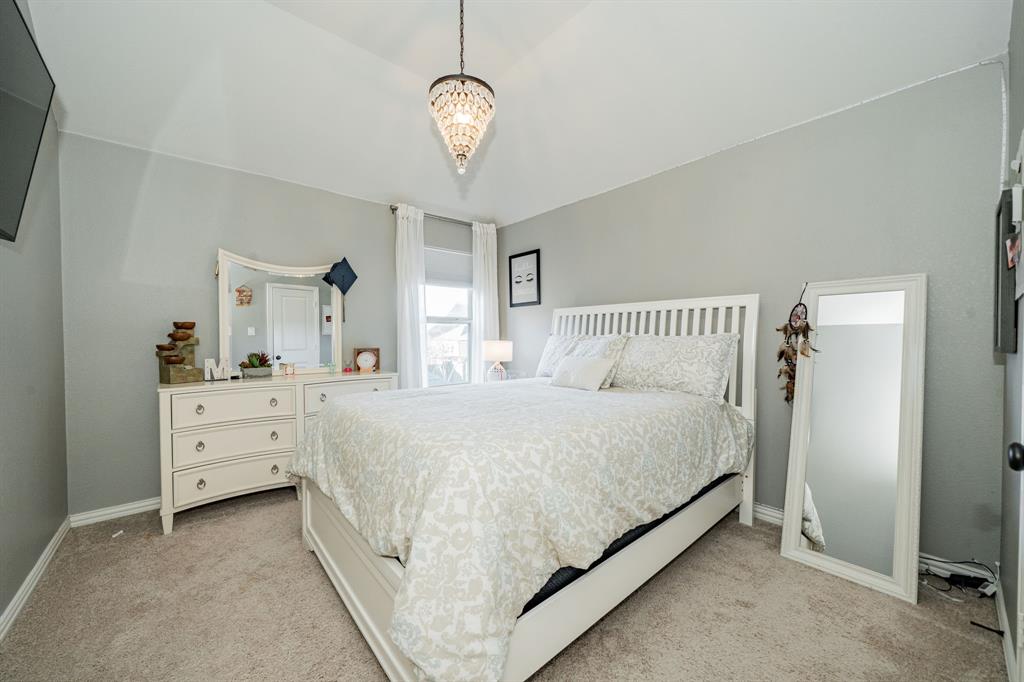 944 Highpoint Way Roanoke, TX 76262 - Photo 33 of 39 a spacious bedroom with a bed and a dresser