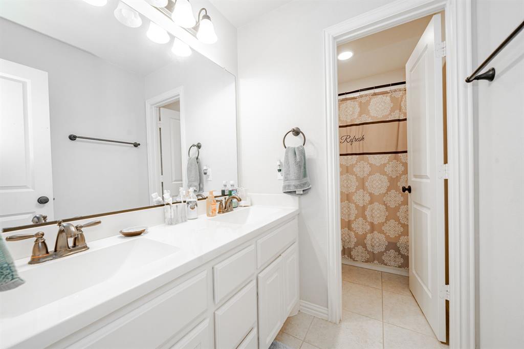 944 Highpoint Way Roanoke, TX 76262 - Photo 34 of 39 a bathroom with a double vanity sink mirror and double